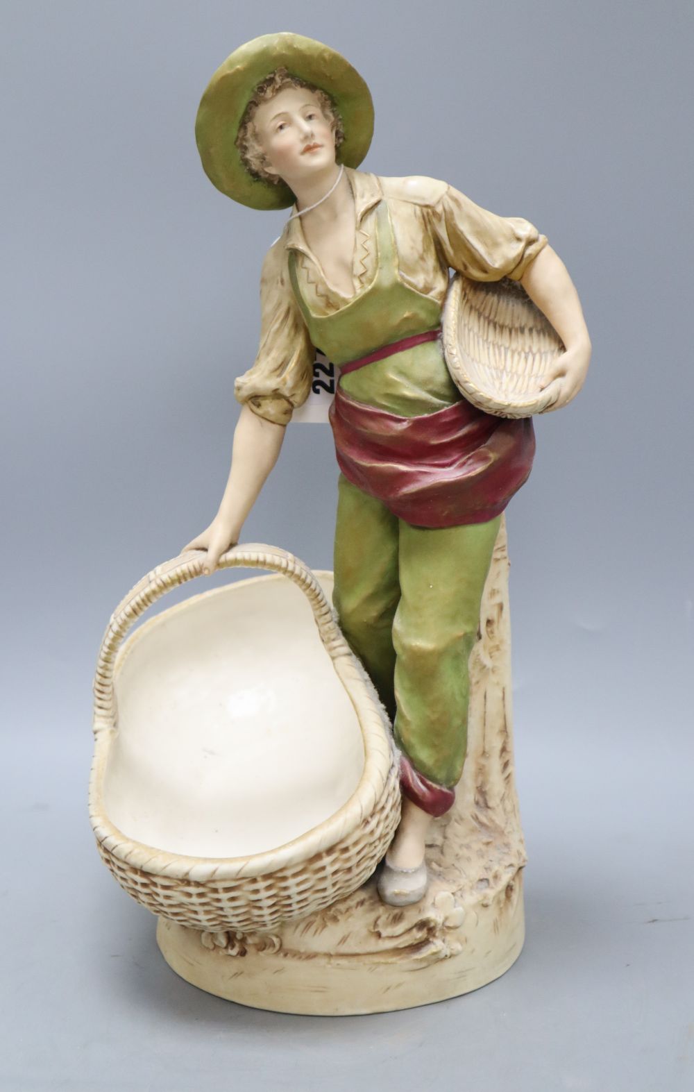 A Royal Dux figure of a boy carrying baskets, height 40cm